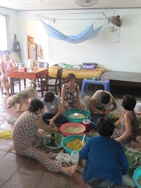 My relative gathered round and preparing traditional banh tet